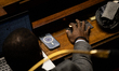 An MP deputy votes in the hemicycle of the National Assembly during the public debate on t...