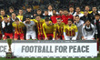 The players from both teams pose together at the end of the match between the national tea...