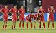 The players of Korea DPR look dejected following their defeat in the penalty shoot-out in...
