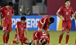 The players of Korea DPR look dejected following their defeat in the penalty shoot-out in...