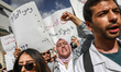 A young doctor shouts slogans while raising her fist during a rally organized by the Tunis...