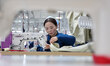 A worker processes women's clothing products in a workshop of a textile and clothing produ...