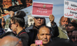 Tunisian journalists raise press cards during a demonstration organized by the National Un...