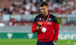 Jean Borg of Malta looks at his mobile phone as he walks on the pitch ahead of the FIFA Wo...