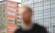 A person walks past a Black Friday Week Amazon billboard in Warsaw, Poland, on November 21...