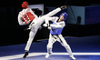 Huang Kefen of China competes against Jongmyeong Kim of Korea in the Men's 58kg category d...
