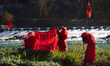 The Red Rebel Brigade performs on a small island formed by the unusually low flow of the r...