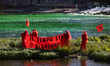 The Red Rebel Brigade performs on a small island formed by the unusually low flow of the r...