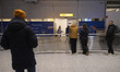 Passengers arriving at the Arrivals area of the airport terminal after the significant del...