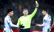 Referee Alex Bos gives FC Groningen midfielder Stije Resink a yellow card during the match...