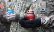 Servicewomen hold lit candles during an event honoring women who die for Ukraine at the Na...