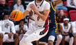 ZION CRUZ (0) drives the ball for the Rider Broncs during an NCAA men's basketball game at...