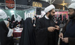 Two Iranian clerics speak with each other at the International Teenager Without Borders Fe...
