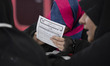 A veiled teenager holds a form with a Persian title reading ''Detective Work on the Web''...