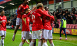 Matt Butcher of Salford City FC celebrates scoring his side's second goal with his teammat...