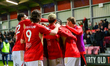 Matt Butcher of Salford City FC celebrates scoring his side's second goal with his teammat...