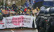 A protester stands in front of police in Giessen, Germany, on November 28, 2025, during a...