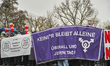 A protest banner reads ''Keine*r bleibt alleine, uberall und jeden Tag!'' (''No one is lef...