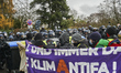 Protesters push bins toward police to break through in Giessen, Germany, on November 28, 2...
