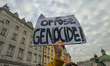 KRAKOW, POLAND – NOVEMBER 29:An activist holds a placard reading 'I Oppose Genocide!' as...