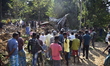 Villagers watch the demolition of their houses by local authorities during an eviction dri...