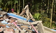 Workers of the Assam forest department demolish an illegal construction inside the Lutumar...