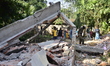 Workers of the Assam forest department demolish an illegal construction inside the Lutumar...