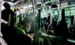 People reflect in a glass window of a metro train in Tokyo, Japan, on November 29, 2025. 