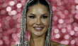 Indian film actress Sunny Leone reacts during her photoshoot on the red carpet as she arri...