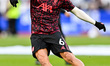Milos Kerkez of Liverpool warms up before the Premier League match between West Ham United...