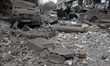 Damaged cars are seen outside a building affected by a Russian missile strike in Dnipro, U...