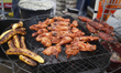 Roasted plantains and chickens are put on fire during the Firewood Jollof Festival 2.0 at...