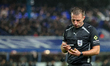 Referee Adam Herczeg makes a note of the caution during the Sky Bet Championship match bet...