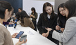 Journalists test the Galaxy Z TriFold, Samsung's new three-fold smartphone, during a media...