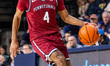 Jay Jones (4) of the Penn Quakers possesses the ball during an NCAA men's basketball game...