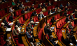 French MP deputies are seen at the hemicycle during the public session for the adoption of...