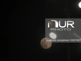 The last supermoon, also known as the cold moon, rises behind the street lights in Srinagar, Kashmir, India, on December 4, 2025.  by Faisal Khan/NurPhoto