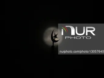 The last supermoon, also known as the cold moon, rises behind the mosque minaret clouds in Srinagar, Kashmir, India, on December 4, 2025.  by Faisal Khan/NurPhoto