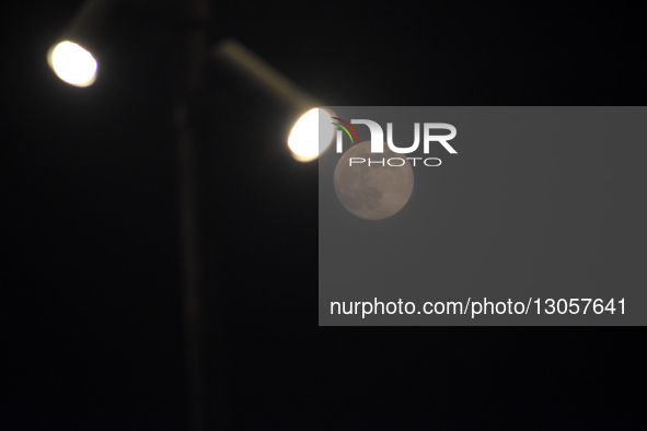 The last supermoon, also known as the cold moon, rises behind the street lights in Srinagar, Kashmir, India, on December 4, 2025.  by Faisal Khan/NurPhoto