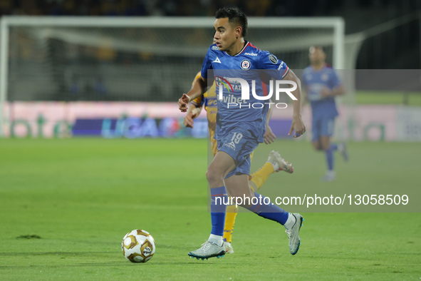 Carlos Rodriguez #19 of Cruz Azul runs with the ball during the first leg semifinal match of Liga MX between Club Tigres and Cruz Azul at Es... by Eyepix/NurPhoto