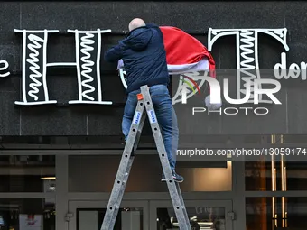 KATOWICE, POLAND – DECEMBER 4:
A man decorates a shop sign with Christmas ornaments in central Katowice, Silesian Voivodeship, Poland, on De... by Artur Widak/NurPhoto