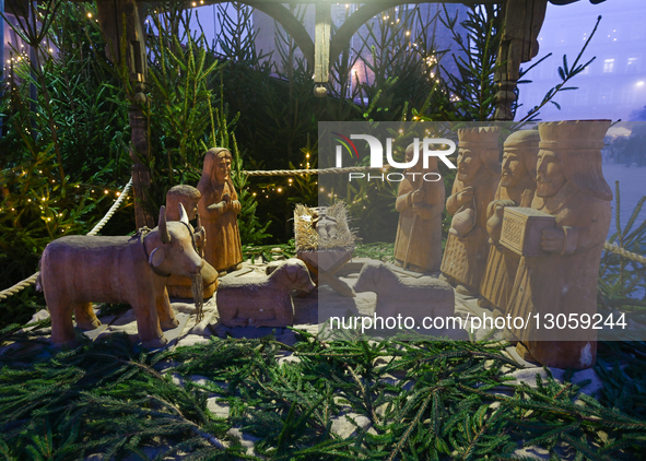 KRAKOW, POLAND - DECEMBER 4:
A wooden Nativity scene is displayed at the Christmas Market in Krakow's Main Market Square amid dense afternoo... by Artur Widak/NurPhoto