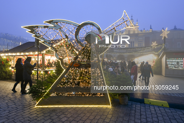 KRAKOW, POLAND - DECEMBER 4:
An angel figure illuminates Christmas decorations at the Christmas Market in Krakow's Main Market Square amid d... by Artur Widak/NurPhoto