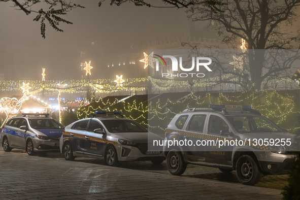 KRAKOW, POLAND – DECEMBER 4:
A line of City Police vehicles is parked along the Christmas Market in Krakow’s UNESCO-listed Main Market Squar... by Artur Widak/NurPhoto