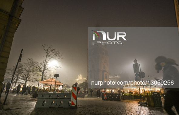 KRAKOW, POLAND – DECEMBER 4:
The Town Hall Tower is seen in Krakow’s UNESCO-listed Main Market Square, with security barriers protecting ent... by Artur Widak/NurPhoto