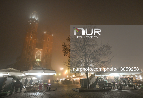 KRAKOW, POLAND – DECEMBER 4:
A view of Krakow’s Main Market Square and St. Mary’s Basilica amid dense afternoon fog, in Krakow, Poland, on D... by Artur Widak/NurPhoto