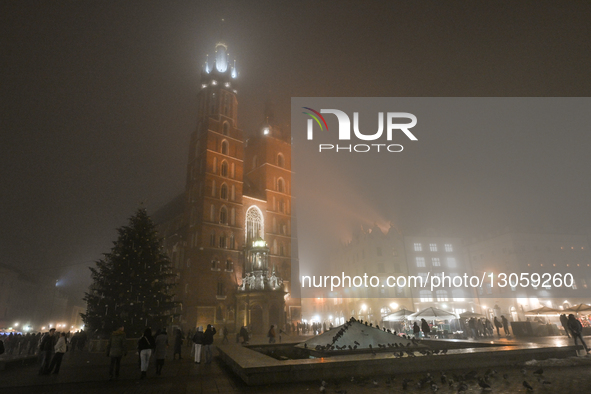 KRAKOW, POLAND – DECEMBER 4:
A view of Krakow’s Main Market Square and St. Mary’s Basilica amid dense afternoon fog, in Krakow, Poland, on D... by Artur Widak/NurPhoto