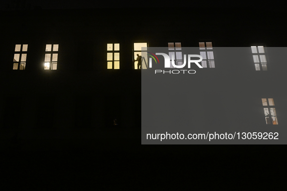 KRAKOW, POLAND – DECEMBER 4:
A man works at a window inside an apartment building as dense fog blankets Krakow, Poland, on December 4, 2025.... by Artur Widak/NurPhoto
