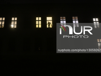 KRAKOW, POLAND – DECEMBER 4:
A man works at a window inside an apartment building as dense fog blankets Krakow, Poland, on December 4, 2025.... by Artur Widak/NurPhoto