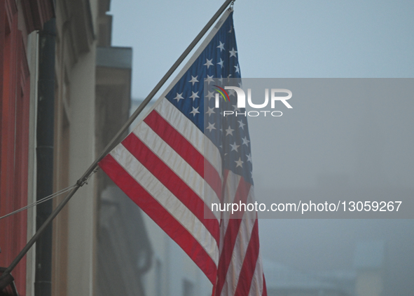KRAKOW, POLAND - DECEMBER 4:
An American flag flies outside the U.S. Consulate amid dense afternoon fog in Krakow, Poland, on December 4, 20... by Artur Widak/NurPhoto